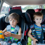 Two kids in car seats.jpg.crdownload