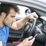 Man-on-his-cell-while-driving