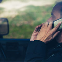 A man talking on phone while driving